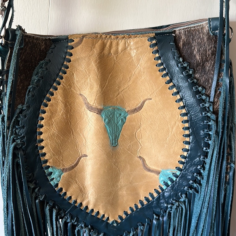 One of a kind custom made cowhide purse hand tooled longhorn on it!